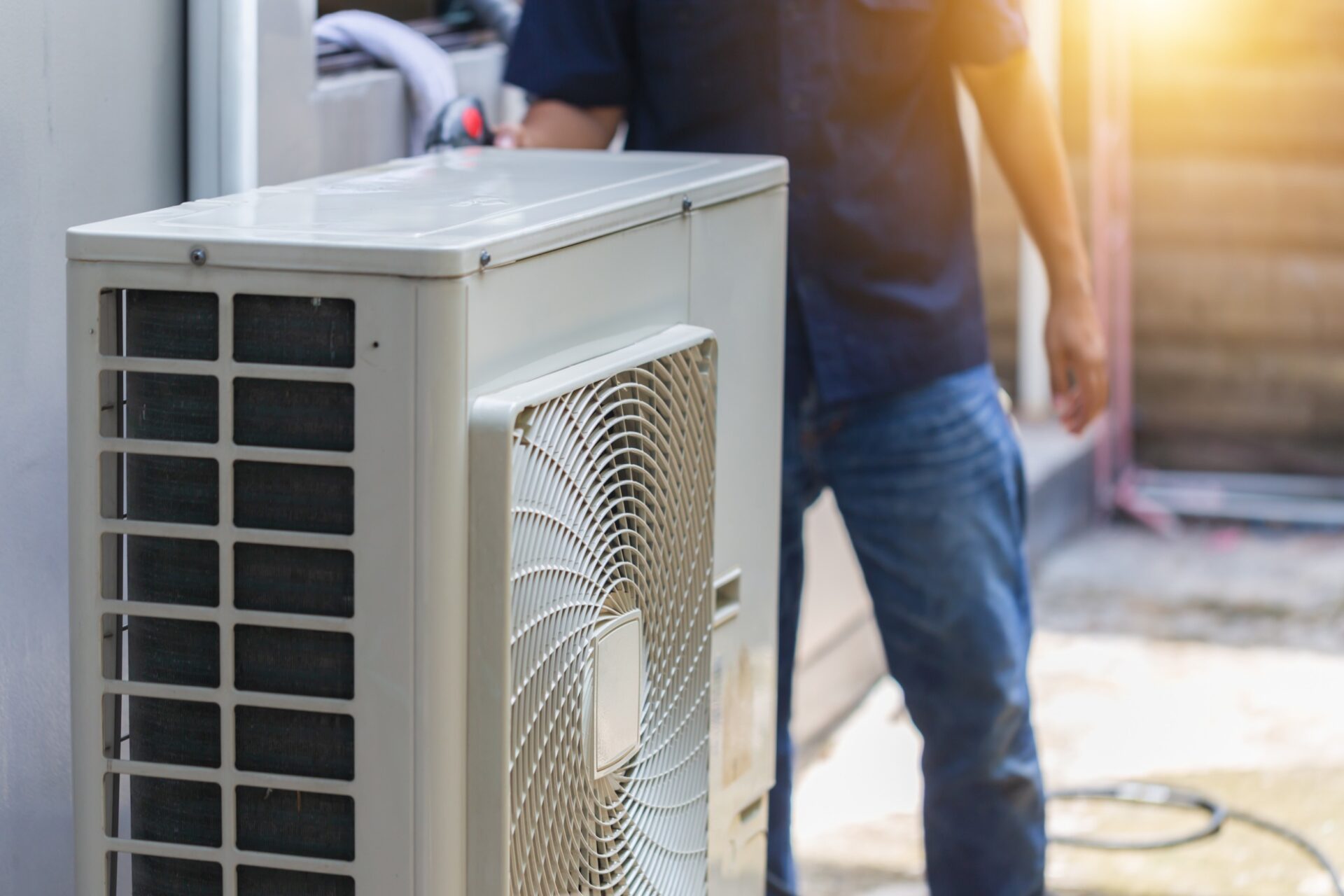 man repairing an ac unit