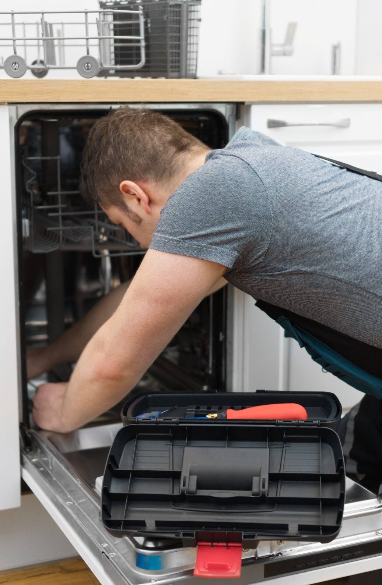 man fixing a dish washer