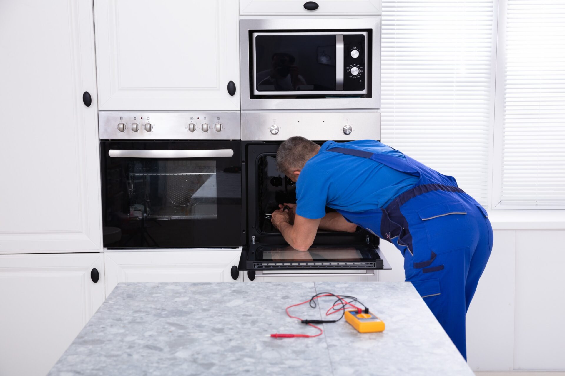 person fixing a stove